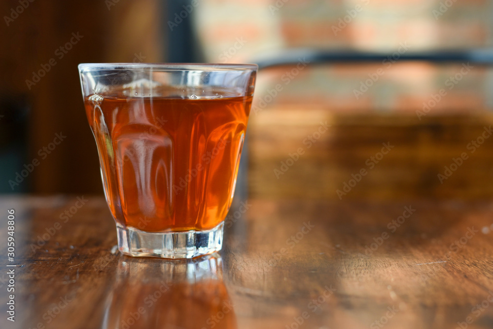 Focus view beverage in a glass on wooden table. Focus view beverage in a glass on wooden table.
