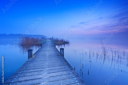 Boardwalk over water at dawn in The Netherlands