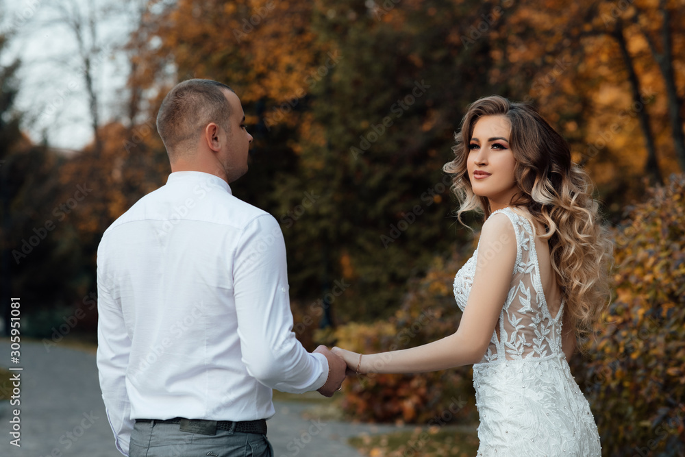 Autumn love story of a young couple. The guy and the girl are hugging. Young people love each other. Autumn walk. Young happy couple on a walk in the park Autumn love story of a young couple. The guy and the girl are hugging. Young people love each other. Autumn walk. Young happy couple on a walk in the park