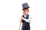 kid actor in the theatre, stylish boy in hat isolated on white background, happy child actor with a cane in his hand dressed in a black suit, talented red curly boy playing in the theatre