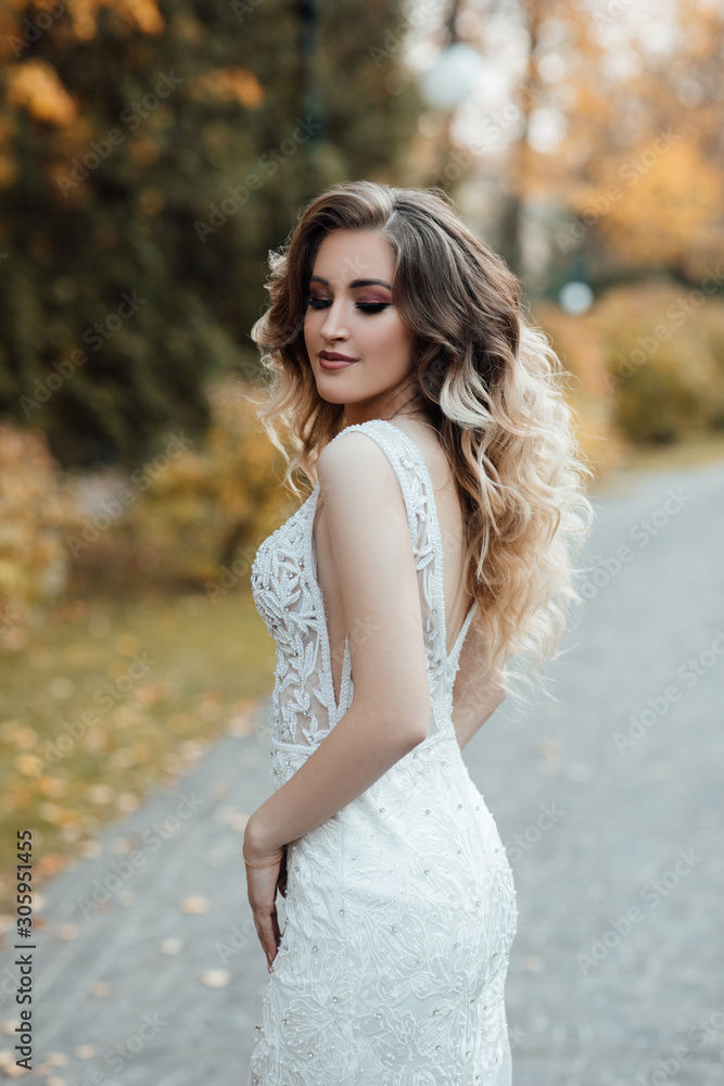 Female fashion. Beautiful fashion woman, model with shiny healthy long volume hair. Waves curls updo volume hairstyle. Makeup. Girl with luxurious haircut. Young woman enjoying autumn weather. Female fashion. Beautiful fashion woman, model with shiny healthy long volume hair. Waves curls updo volume hairstyle. Makeup. Girl with luxurious haircut. Young woman enjoying autumn weather.