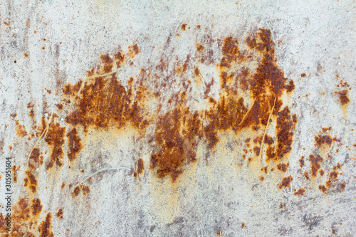 White corroded metal background. Rusty and scratched painted metal wall. Rusty metal background with streaks of rust .