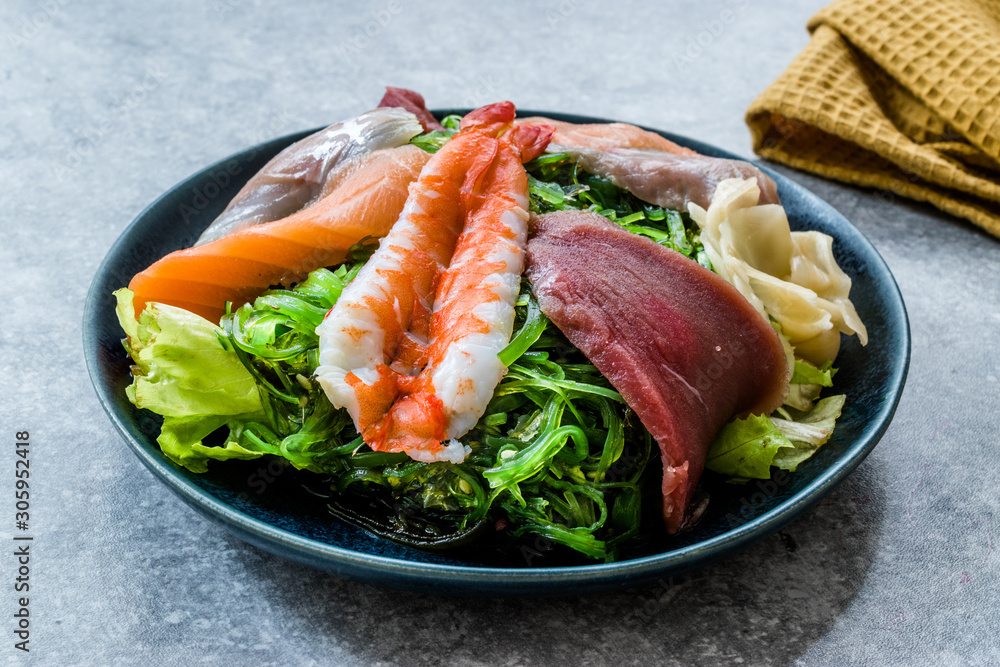 Sashimi Salad with Wakame, Seaweed, Salmon, Sea Bass, Shrimp, Kani, Mackerel Fish, Tuna served with Chopsticks. Sashimi Salad with Wakame, Seaweed, Salmon, Sea Bass, Shrimp, Kani, Mackerel Fish, Tuna served with Chopsticks.