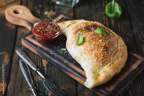 Calzone pizza with chicken and cheese photo