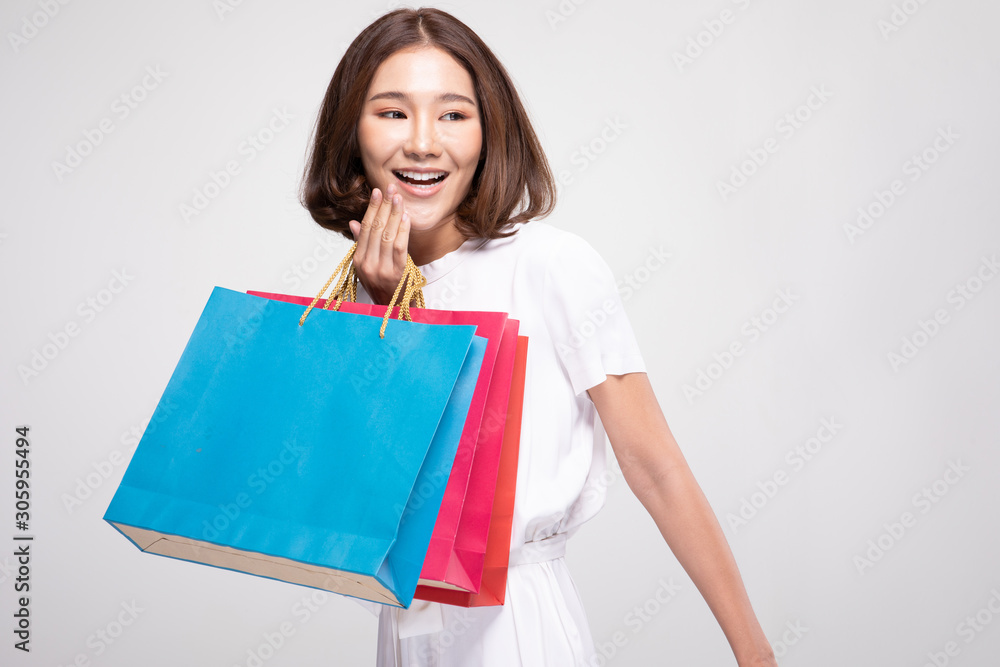Shopping Asian woman with short hairs smile and Holding Shopping bags, Cheerful and happiness emotional, Enjoy Shopping in black friday sale, Isolated on gray background, Shopping Concept Shopping Asian woman with short hairs smile and Holding Shopping bags, Cheerful and happiness emotional, Enjoy Shopping in black friday sale, Isolated on gray background, Shopping Concept