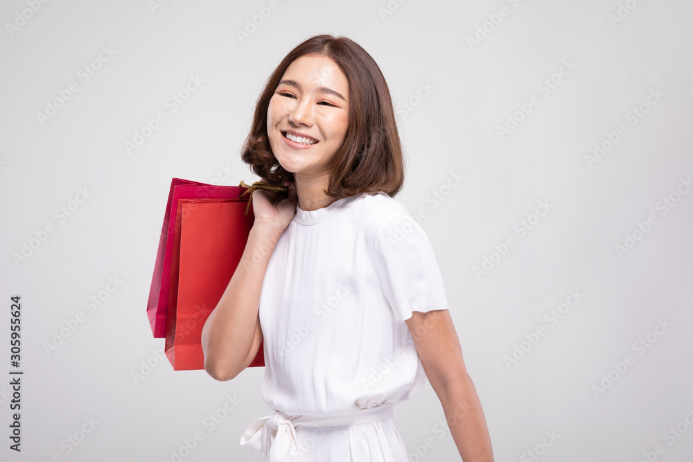 Shopping Asian woman with short hairs smile and Holding Shopping bags, Cheerful and happiness emotional, Enjoy Shopping in black friday sale, Isolated on gray background, Shopping Concept Shopping Asian woman with short hairs smile and Holding Shopping bags, Cheerful and happiness emotional, Enjoy Shopping in black friday sale, Isolated on gray background, Shopping Concept