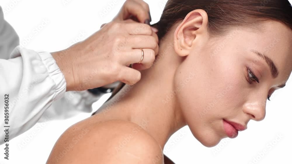 cropped view of stylist doing pony tail to woman cropped view of stylist doing pony tail to woman