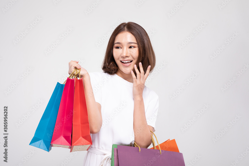 Shopping Asian woman with short hairs smile and Holding Shopping bags, Cheerful and happiness emotional, Enjoy Shopping in black friday sale, Isolated on gray background, Shopping Concept Shopping Asian woman with short hairs smile and Holding Shopping bags, Cheerful and happiness emotional, Enjoy Shopping in black friday sale, Isolated on gray background, Shopping Concept
