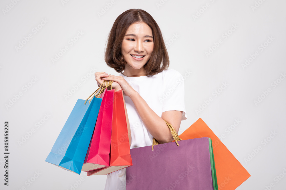 Shopping Asian woman with short hairs smile and Holding Shopping bags, Cheerful and happiness emotional, Enjoy Shopping in black friday sale, Isolated on gray background, Shopping Concept Shopping Asian woman with short hairs smile and Holding Shopping bags, Cheerful and happiness emotional, Enjoy Shopping in black friday sale, Isolated on gray background, Shopping Concept