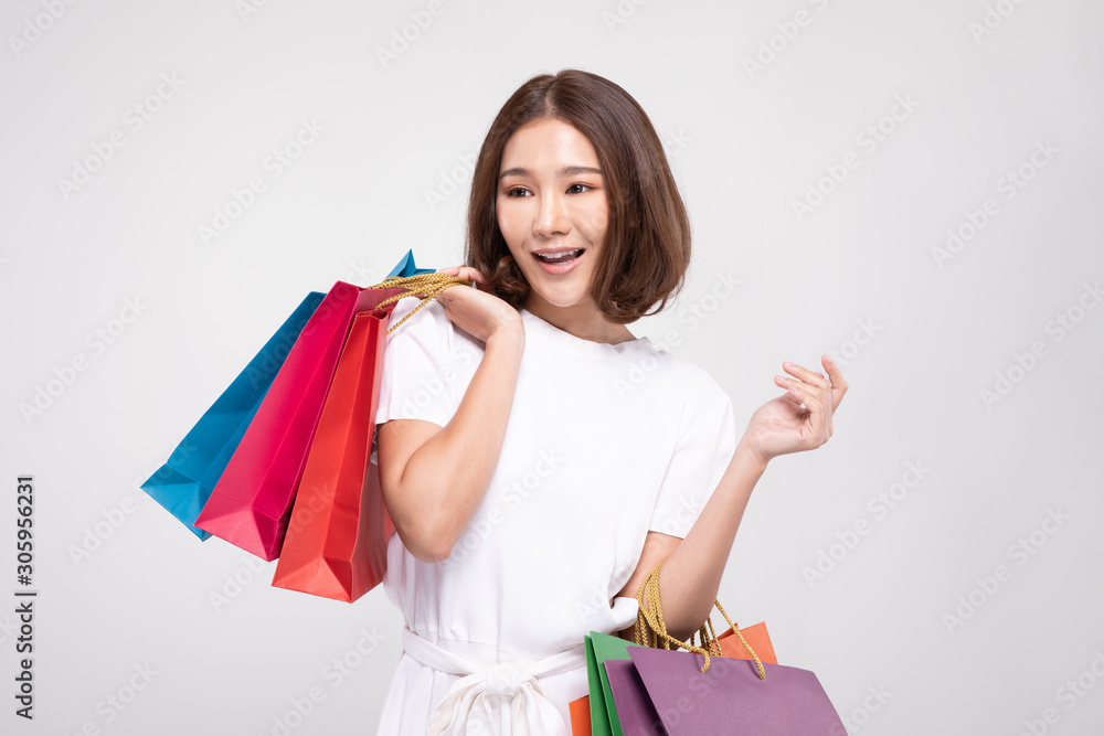 Shopping Asian woman with short hairs smile and Holding Shopping bags, Cheerful and happiness emotional, Enjoy Shopping in black friday sale, Isolated on gray background, Shopping Concept Shopping Asian woman with short hairs smile and Holding Shopping bags, Cheerful and happiness emotional, Enjoy Shopping in black friday sale, Isolated on gray background, Shopping Concept