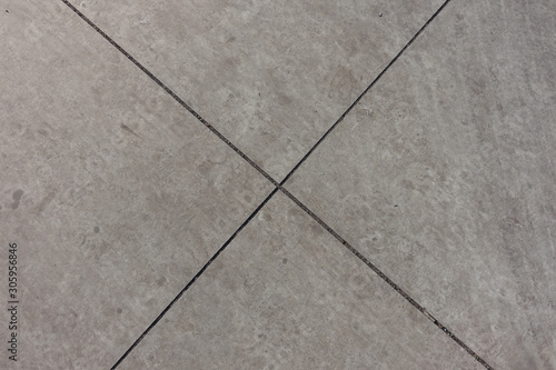 X-shaped joints between light grey concrete slabs