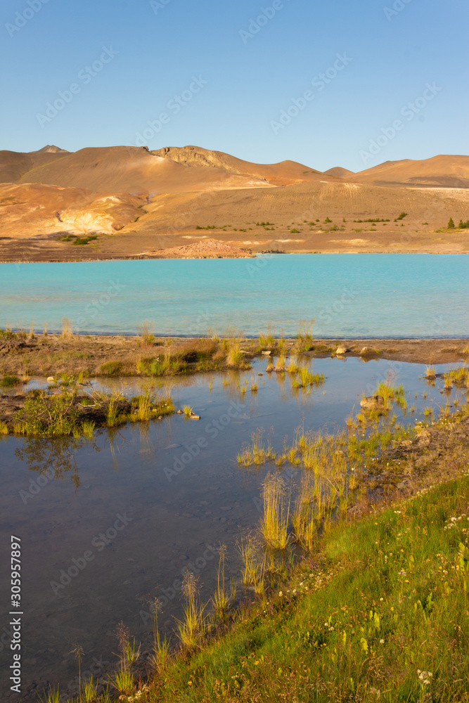 Turquoise geothermal sulfur lake, lagoon in the desert mountains