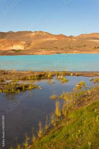 Turquoise geothermal sulfur lake, lagoon in the desert mountains