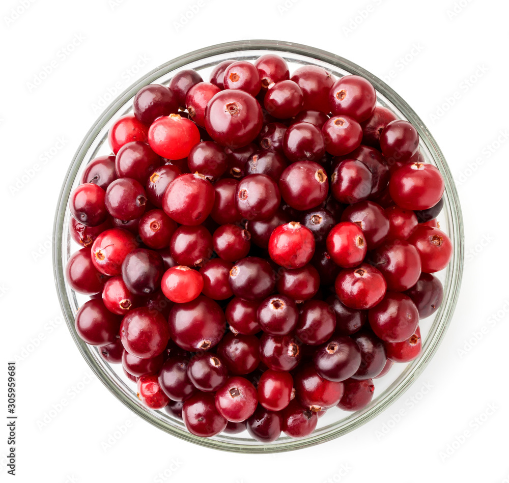 Ripe cranberries in a plate on a white. The view of the top. Ripe cranberries in a plate on a white. The view of the top.
