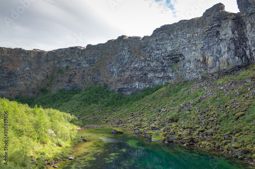 Glacial lake on the bottom of a deep miss, abyss, Iceland Asbyrgi canyon