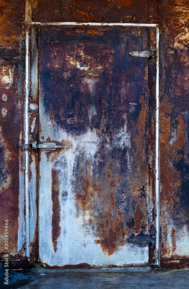 horizontal closed very rusty iron door with a deadbolt, the texture of rust horizontal closed very rusty iron door with a deadbolt, the texture of rust