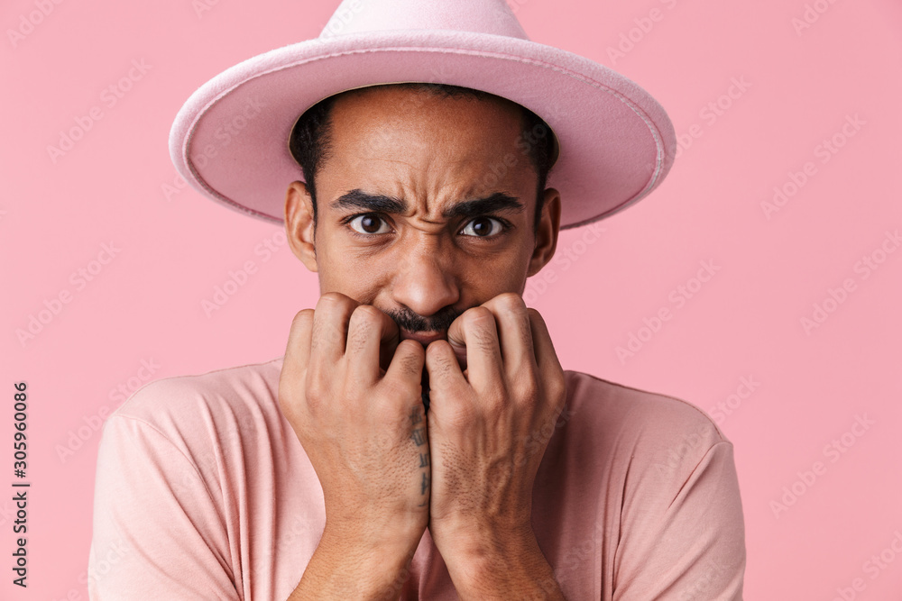 Photo of frightened african american man looking at camera i Photo of frightened african american man looking at camera i