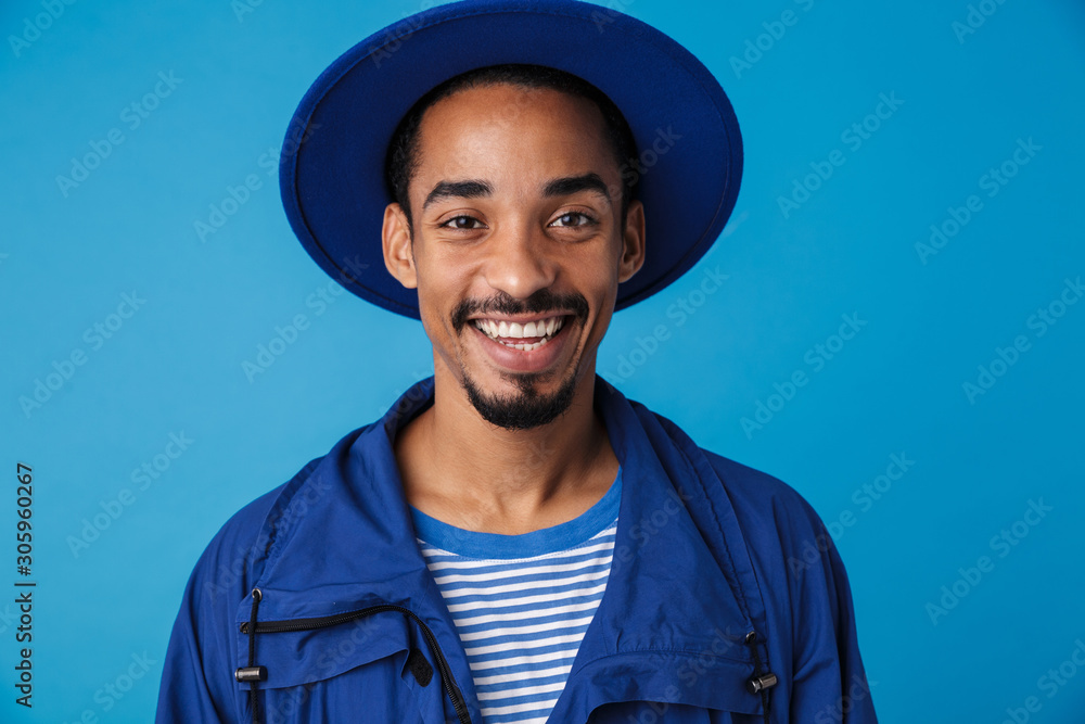 Photo of funny african american man smiling and looking at camera - obrazy, fototapety, plakaty 