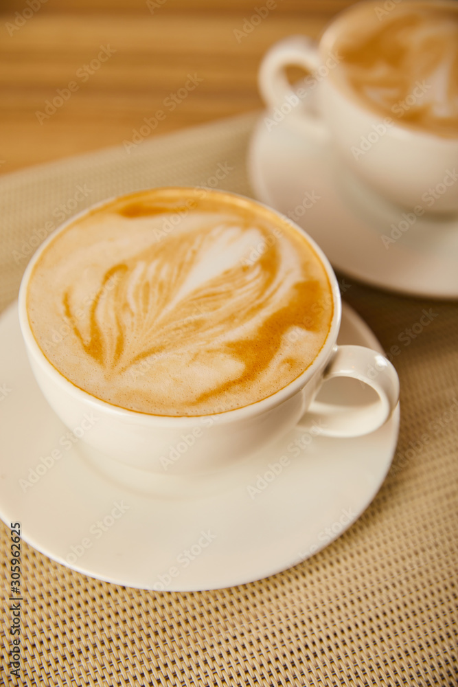 selective focus of tasty cappuccino in white cups on table selective focus of tasty cappuccino in white cups on table