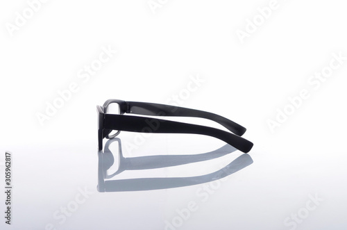 View of black frame spectacles glasses in a white background. Selective focus. 