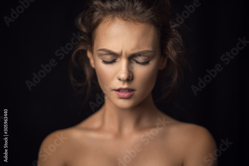 Emotional portrait of a beautiful girl against a background in studio