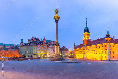 Castle Square with Royal Castle, colorful houses and Sigismund Column in Old town during morning blue hour, Warsaw, Poland.