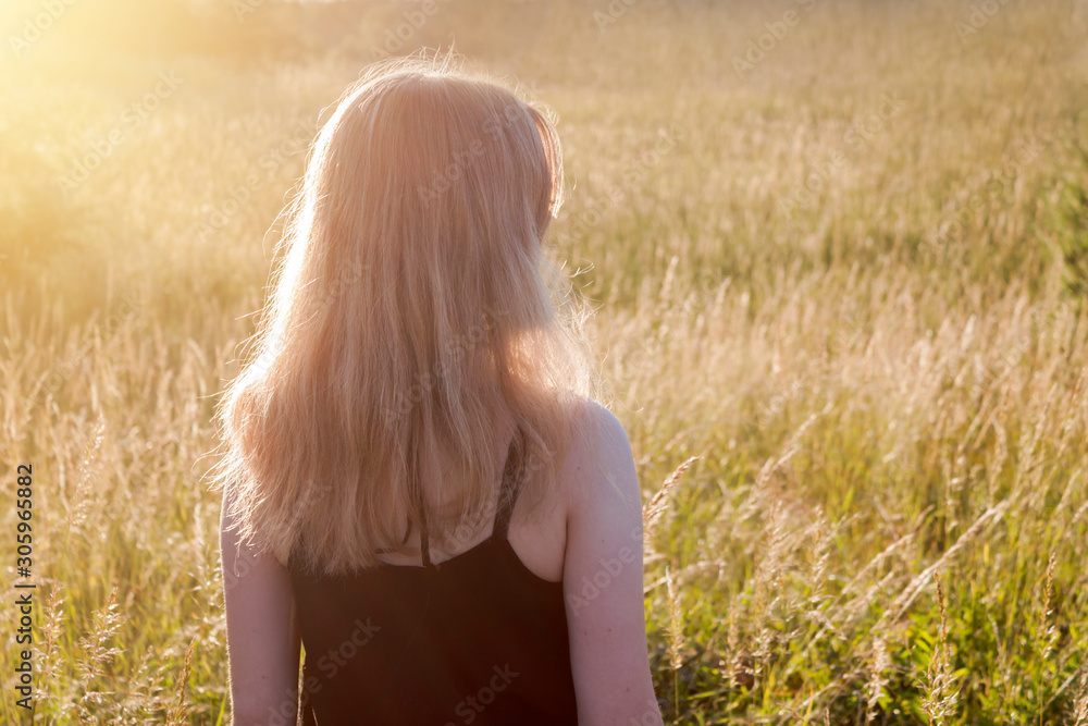 Young woman on meadow in sunlight Young woman on meadow in sunlight