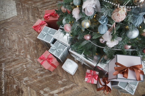 vintage Christmas interior, New Year interior with gift boxes and fir tree. Copy space. Shallow DOF. Top view photo