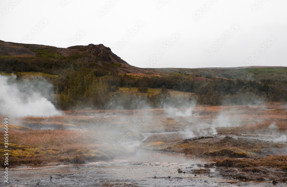 Rusty landscape and steaming hot springs Rusty landscape and steaming hot springs