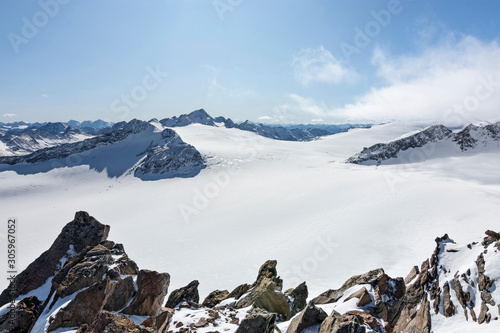 Snow-covered glaciers with rocky mountains at a bright sunny day. Oetztal Alps, Tirol, Austria photo