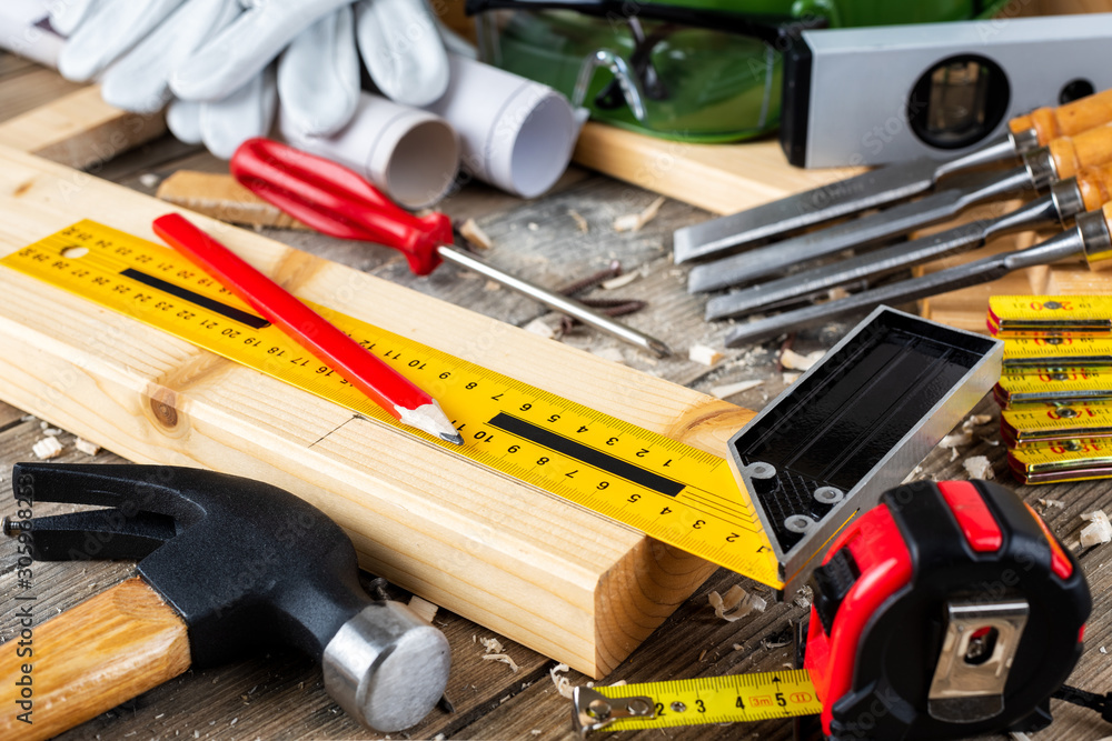 View from above of carpenter's tools on an antique wooden table. Construction industry, do it yourself. Wooden work table. View from above of carpenter's tools on an antique wooden table. Construction industry, do it yourself. Wooden work table.