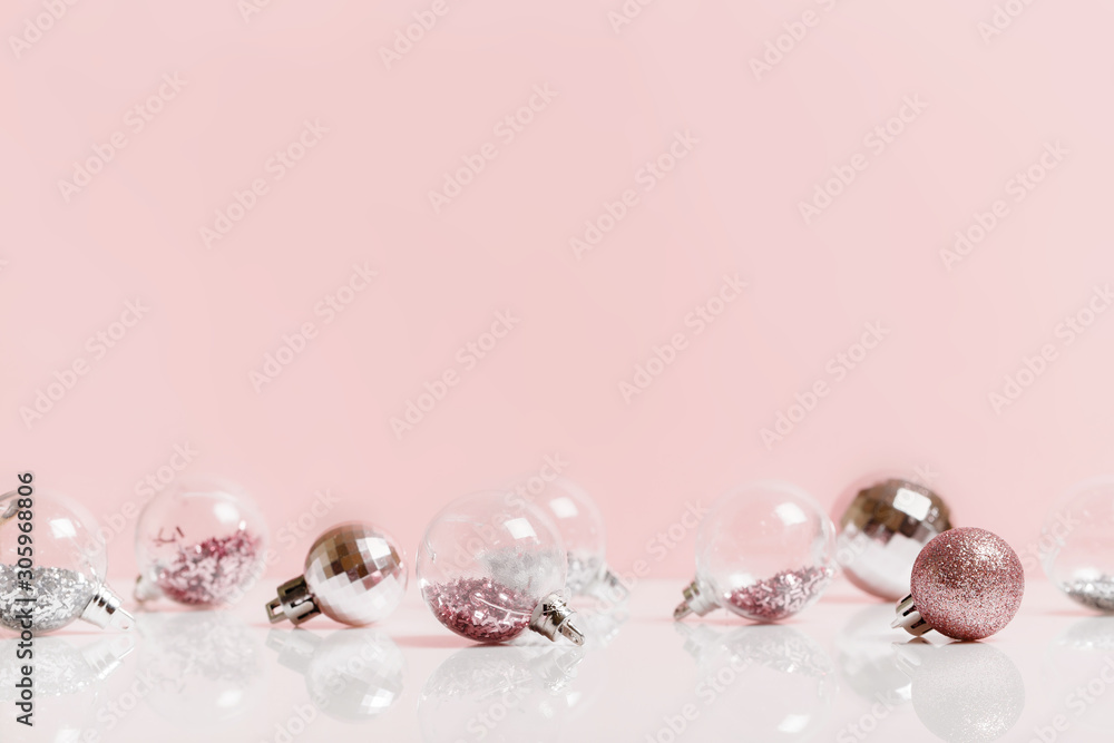 Christmas composition. Frame made of balls and snowflakes on pastel pink background. Christmas composition. Frame made of balls and snowflakes on pastel pink background.