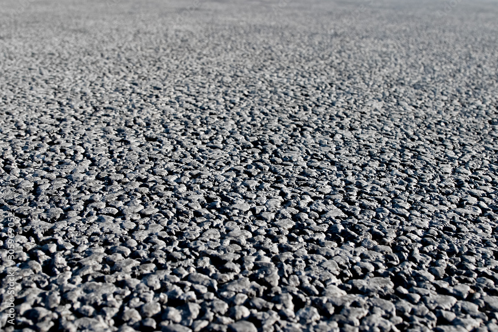 Closeup of an asphalt road. Background photo in perspective with selective focus Closeup of an asphalt road. Background photo in perspective with selective focus