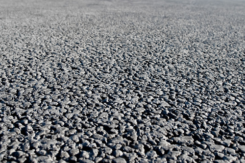 Closeup of an asphalt road. Background photo in perspective with selective focus