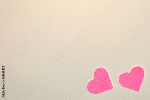 Pink felt hearts on a beige background. Happy Valentine. Flat lay.