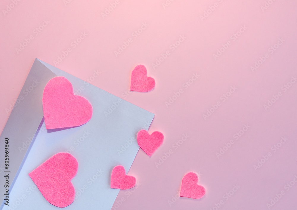 Pink felt hearts and letter on a pink background. Happy Valentine. Flat lay.