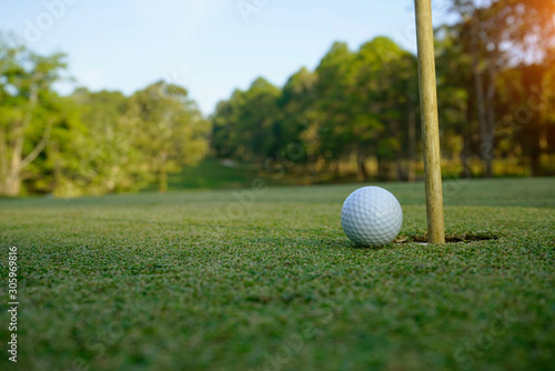 golf ball on green in the evening golf course with sunshine.