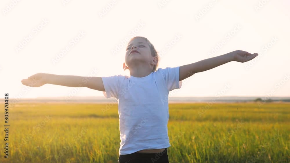 small child hands drawn to heaven concept happy family lifestyle religion. little boy closed his eyes spread his arms to the sides on the nature in the park at sunset slow motion video small child hands drawn to heaven concept happy family lifestyle religion. little boy closed his eyes spread his arms to the sides on the nature in the park at sunset slow motion video