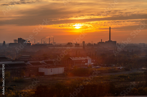 Industrial surroundings at sunset and night
