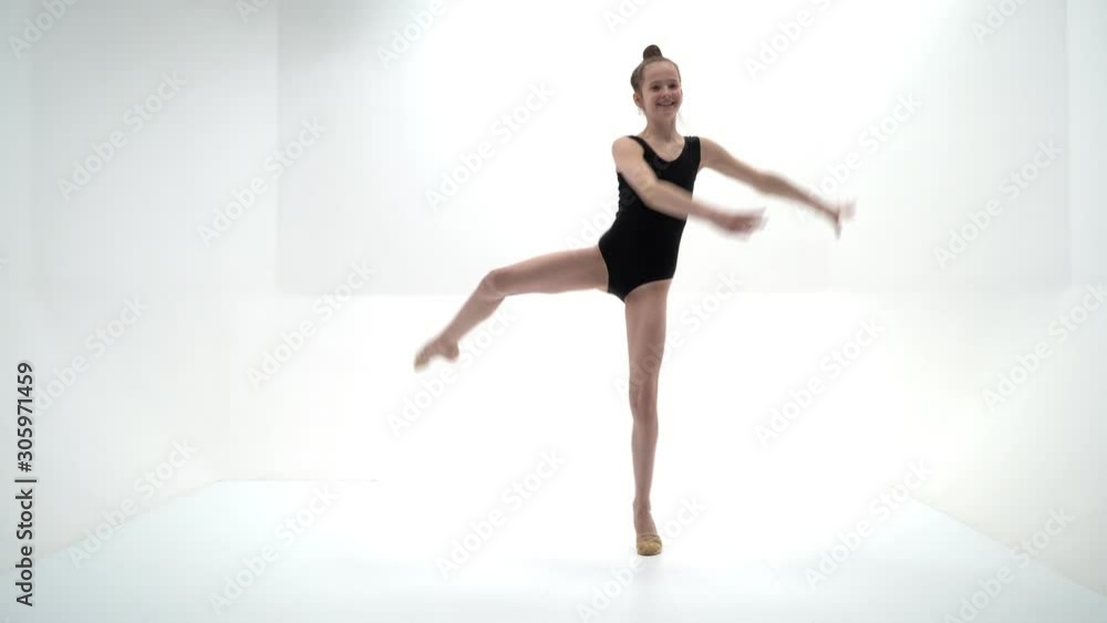 The gymnast balances on one leg. The gymnast balances on one leg.
