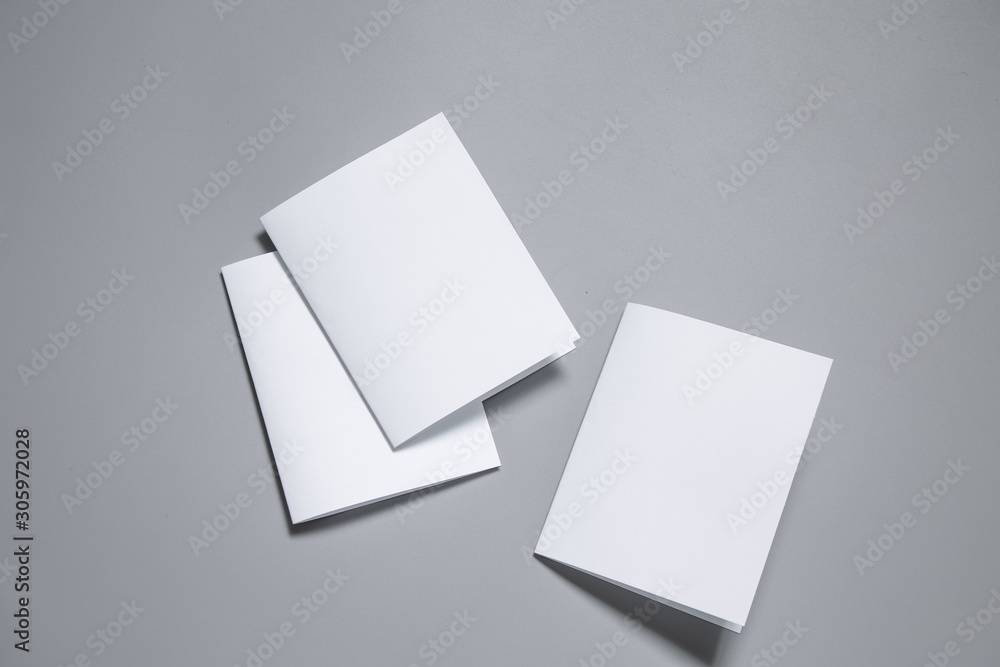 Blank portrait mock-up paper. brochure magazine isolated on gray, changeable background / white paper isolated on gray Blank portrait mock-up paper. brochure magazine isolated on gray, changeable background / white paper isolated on gray
