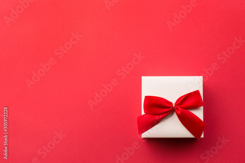 Present white gift box with red bow