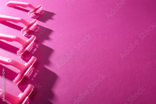 selective focus of disposable razors on pink background