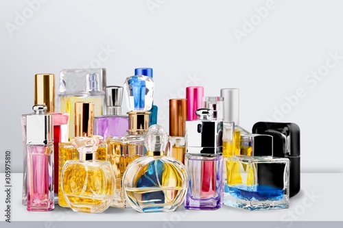 Aromatic Perfume bottles on the wooden desk at wooden background photo