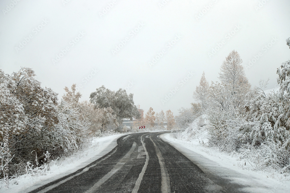 scenic view of empty road with snow covered landscape while snowing in winter season.turkey scenic view of empty road with snow covered landscape while snowing in winter season.turkey