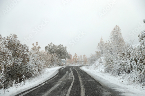 scenic view of empty road with snow covered landscape while snowing in winter season.turkey © murat