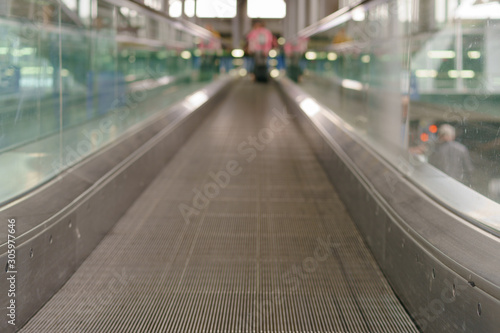 Photography of escalator in the airport in day time. Nobody here  free way. Image with defocused background. Travelling and touristic concepts.