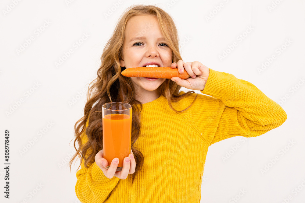 attractive girl in yellow clothes nibbles a carrot holding a glass in her hand with carrot juice isolated white background attractive girl in yellow clothes nibbles a carrot holding a glass in her hand with carrot juice isolated white background