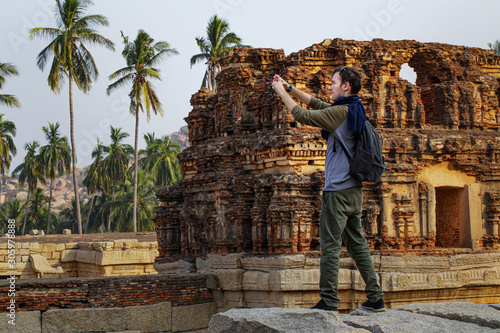 Photography guy tourist shoots photos of tourist attractions