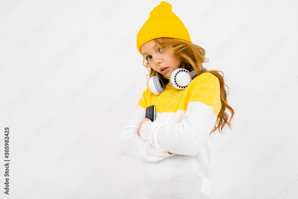 European cute girl with big headphones possing on a white background European cute girl with big headphones possing on a white background
